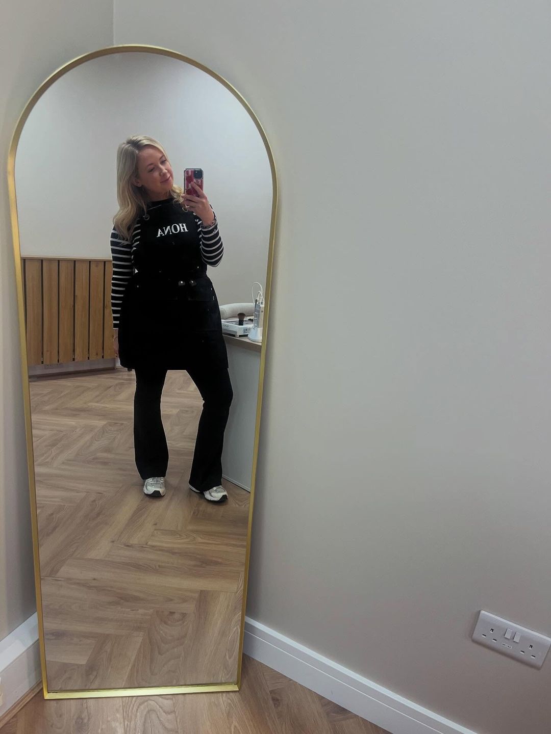 Becky taking a mirror selfie in the studio